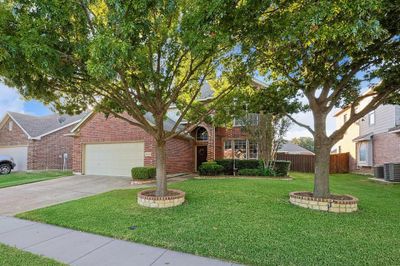 View of front facade featuring cooling unit, a front lawn, and a garage | Image 2