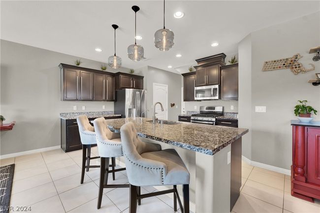 Large kitchen island with breakfast bar and granite counters | Image 9