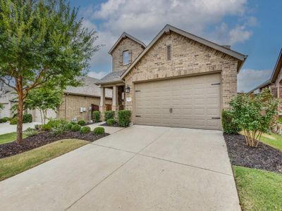 The exterior includes custom landscaping and covered porch. | Image 3