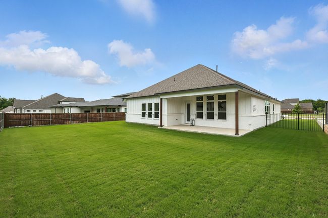Rear view of property featuring a patio, a fenced backyard, and roof with shingles | Image 27