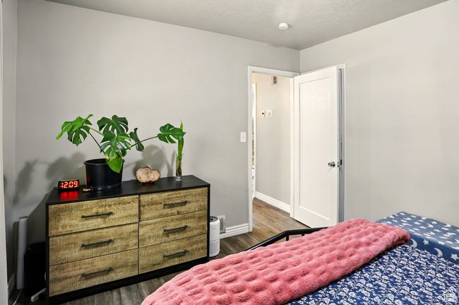 Bedroom featuring wood finished floors and baseboards | Image 17