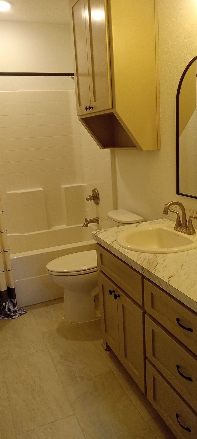 Bathroom with vanity and shower / bathtub combination with curtain | Image 10