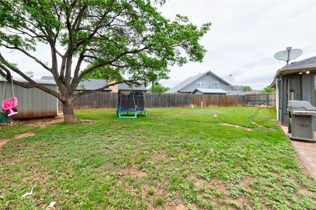 View of yard featuring a fenced backyard and a trampoline | Image 28