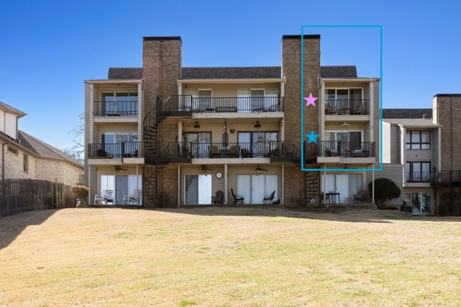 Back of Condo building, looks out over lake, green space and dock. Blue star is living room balcony and pink star is primary suite balcony. | Image 27