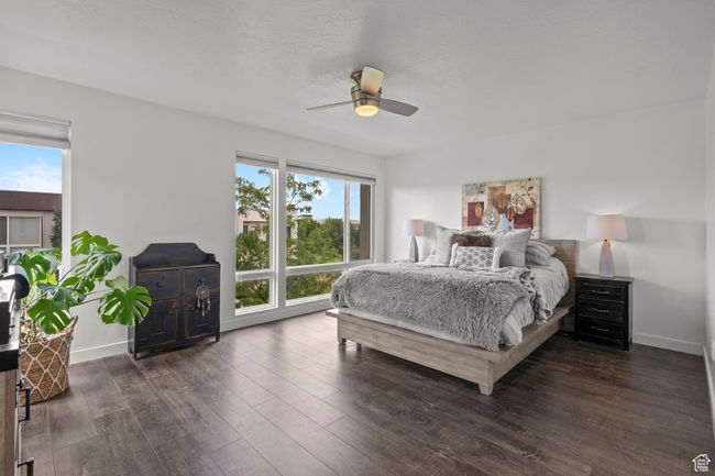 Bedroom with wood finished floors and ceiling fan | Image 18