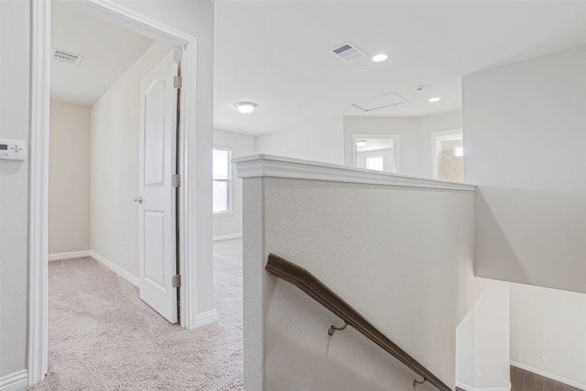 Hallway with an upstairs landing, carpet, recessed lighting, and attic access | Image 25