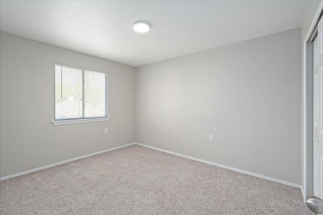 Carpeted empty room with baseboards | Image 26