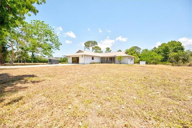 Single story home with a front lawn, driveway, and an attached garage | Image 6