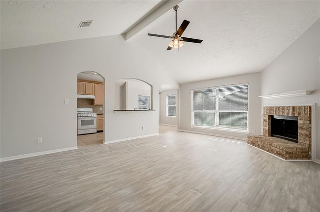 Spacious living room area with luxury vinyl and a fireplace | Image 5
