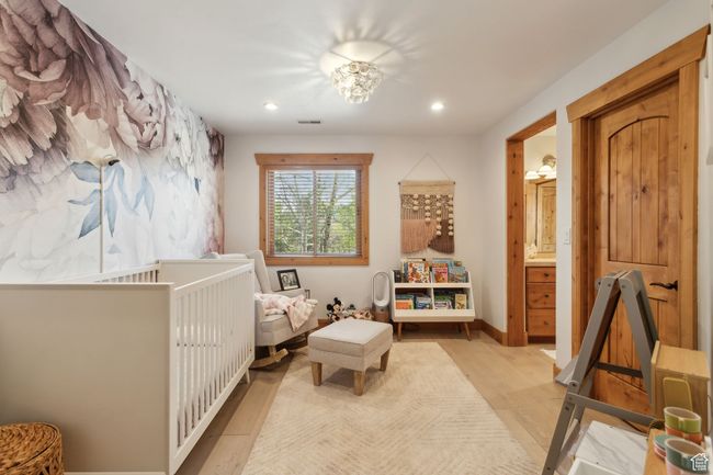 Bedroom with wood finished floors and recessed lighting | Image 31