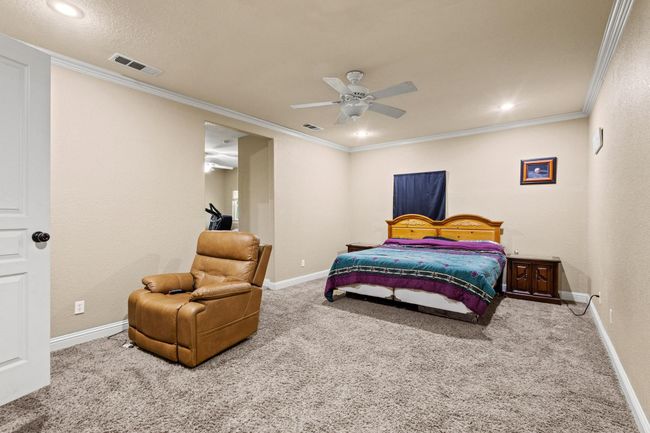 Carpeted bedroom with baseboards, ornamental molding, and visible vents | Image 20