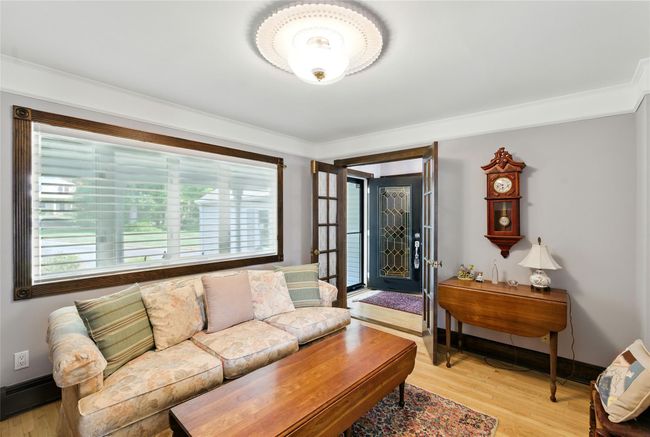 Living area featuring plenty of natural light, a baseboard radiator, and light wood-style flooring | Image 26