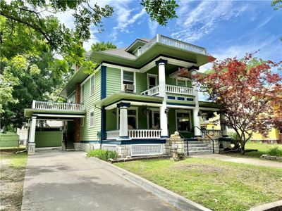 View of front of property featuring a front yard, a porch, and a balcony | Image 2