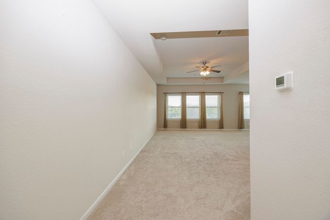 Spare room with a ceiling fan and light colored carpet | Image 33