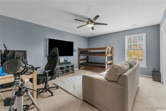 Bedroom with carpet, visible vents, baseboards, and ceiling fan | Image 27