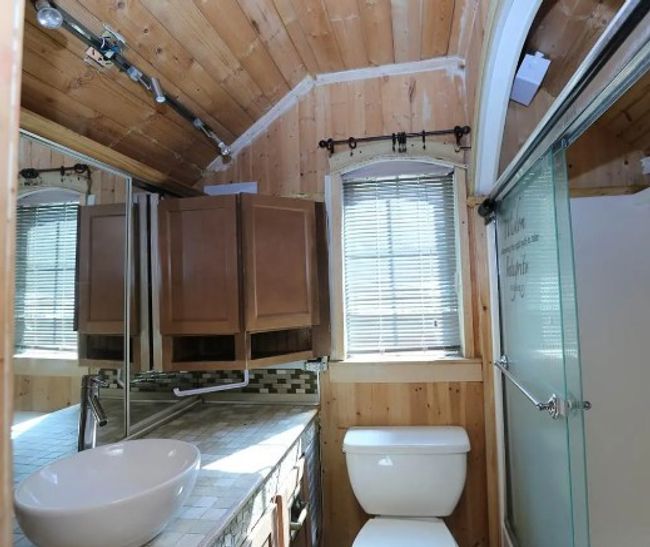 Bathroom with lofted ceiling, wood walls, wooden ceiling, plenty of natural light, and a shower stall | Image 13