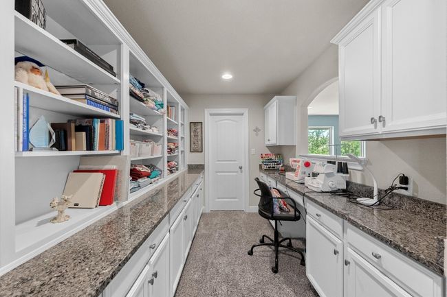 Office area with light colored carpet, arched walkways, built in desk, and recessed lighting | Image 27