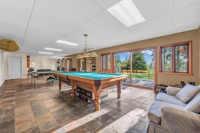 Playroom with stone tile floors and pool table | Image 28