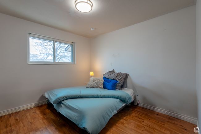 Bedroom with baseboards and wood finished floors | Image 15