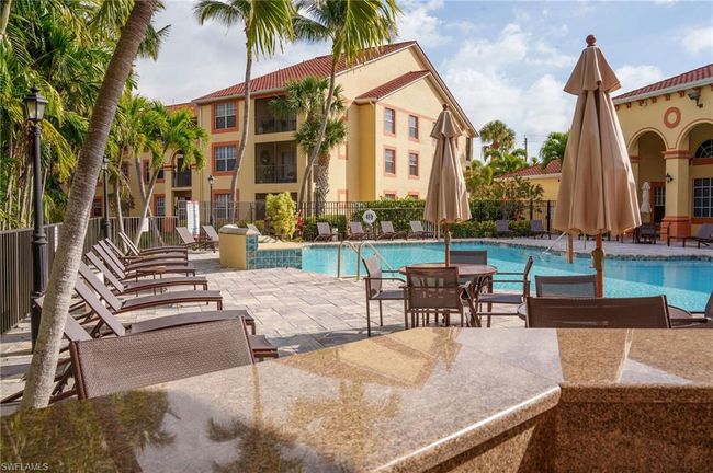 Community pool with a patio and fence | Image 32