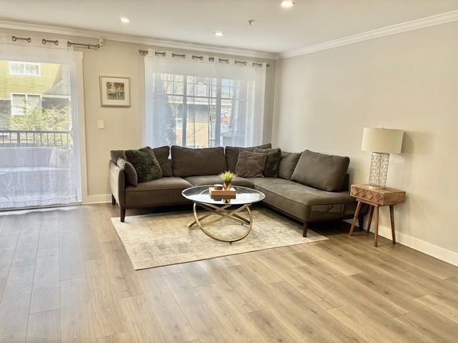 Living room with ornamental molding, light wood finished floors, plenty of natural light, and recessed lighting | Image 4