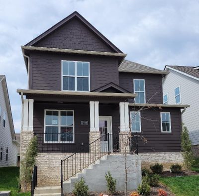 Welcome home! Rocking chair front porch. So many wonderful finishes inside - sand and finish hardwoods, lots of crown, quartz in kitchen and baths. | Image 1