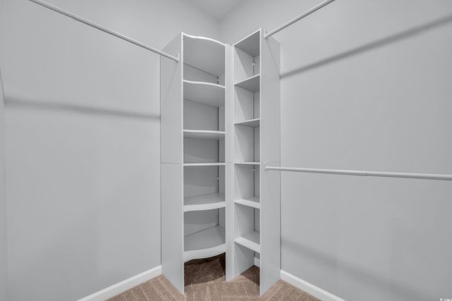 Spacious closet with carpet flooring | Image 11