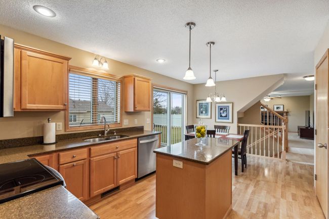 Extra counter space with this center island. Newer stainless steel under-mount sink and updated faucet. | Image 6