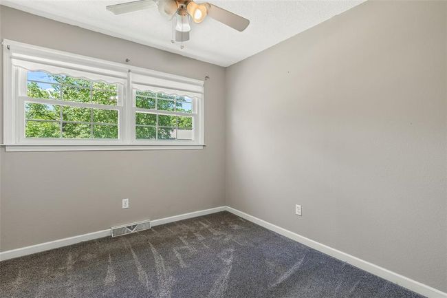 Unfurnished room featuring healthy amount of natural light, ceiling fan, carpet, and baseboards | Image 48