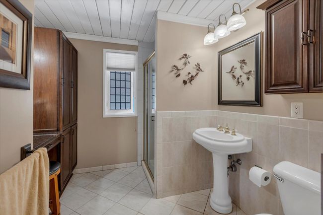 Bathroom featuring crown molding, tile patterned floors, toilet, and walk in shower | Image 18