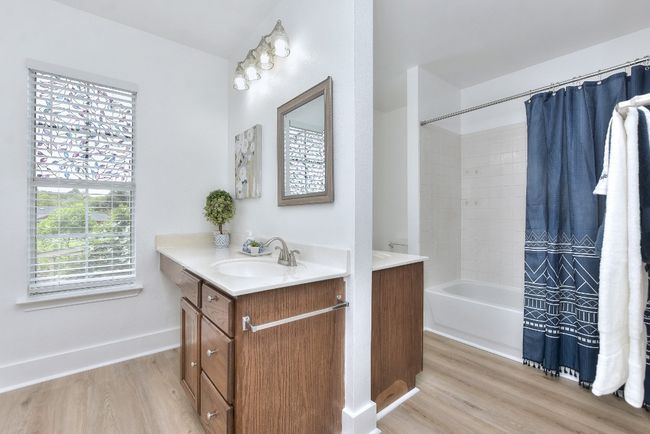 The primary bath features fresh flooring, back-2-back dual vanities, tub/shower combination, linen closet and huge walk-in closet! | Image 26