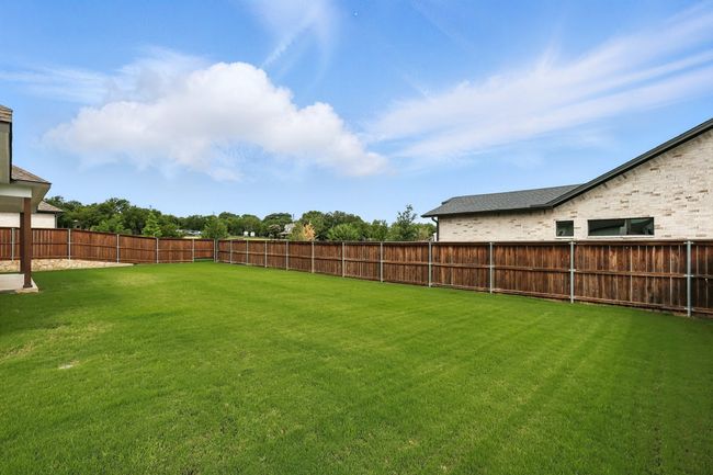 View of fenced backyard | Image 26
