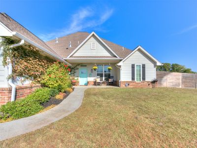 View of front of house featuring covered porch and a front lawn | Image 1