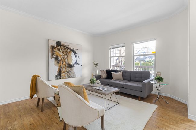 Living area featuring light wood-style floors, crown molding, and baseboards | Image 4