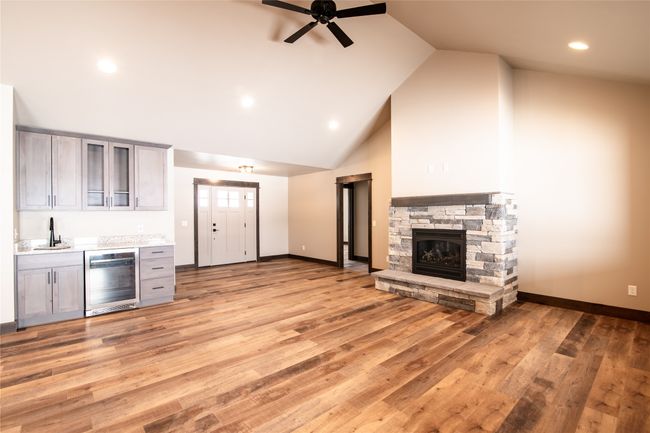 Kitchen featuring wine cooler, a fireplace, gray cabinetry, and light hardwood / wood-style floors | Image 4