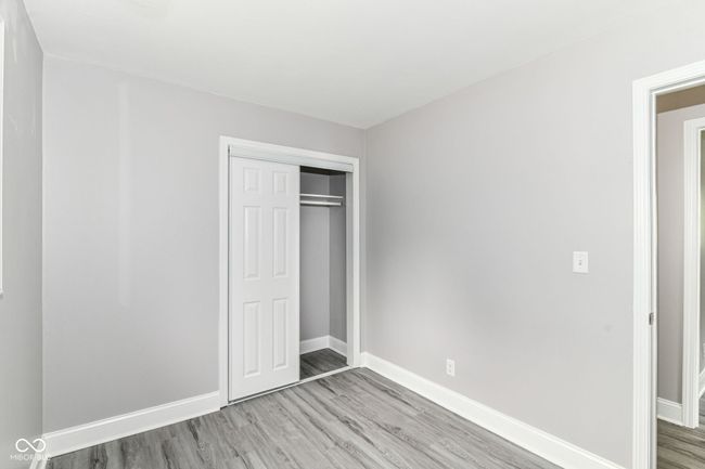 unfurnished bedroom with light wood-type flooring, baseboards, and a closet | Image 21