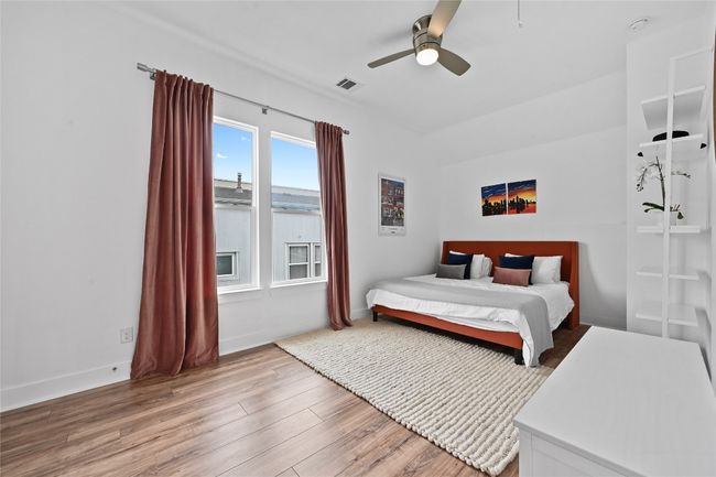 Second level guest bedroom featuring light wood-style flooring and ceiling fan | Image 20