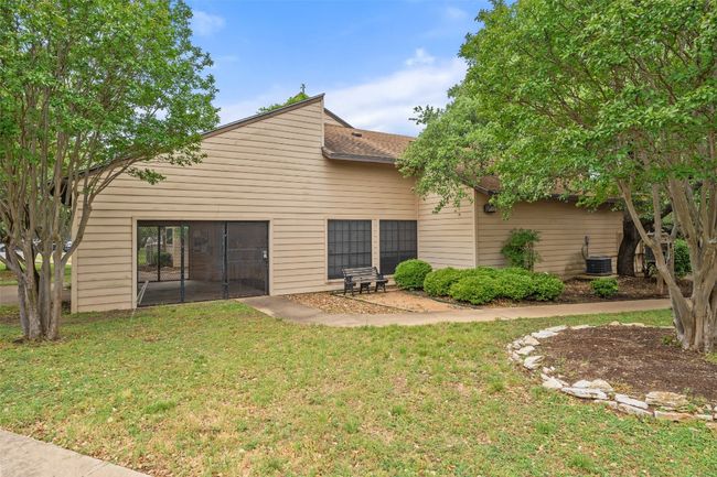 Rear view of property with a shingled roof, a yard, and central AC unit | Image 35