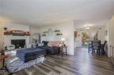 Living room with a fireplace and dark hardwood / wood-style floors | Image 3