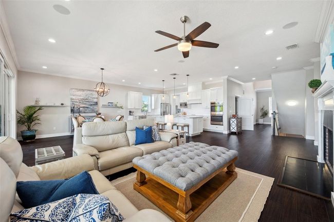 View of the 2nd level living/dining/kitchen open concept space. Wood burning fireplace to right. | Image 24