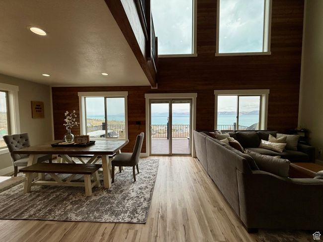 Dining room featuring recessed lighting, wood walls, light wood finished floors, and a healthy amount of sunlight | Image 22