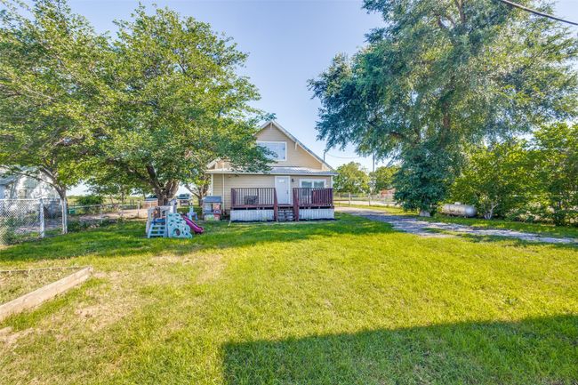 Large back deck overlooking a spacious fenced yard with room to roam, garden, or entertain. | Image 20