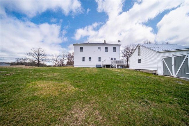 Back of house with an outbuilding, a wooden deck, and a lawn | Image 23