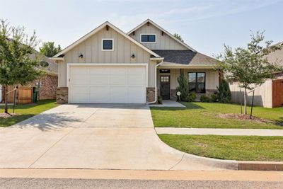 View of front facade with a front yard and a garage | Image 1