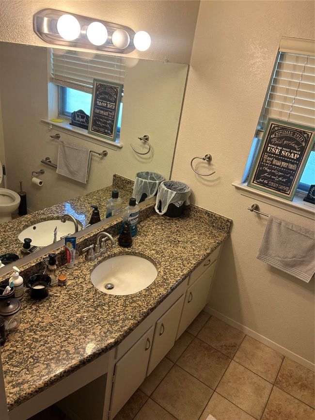 Bathroom featuring tile patterned flooring, vanity, and baseboards | Image 13