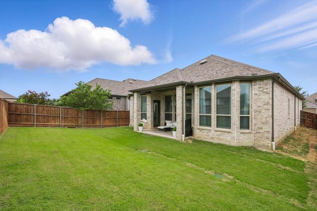 Back of property with brick siding, a fenced backyard, a patio, and roof with shingles | Image 23