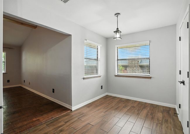 Unfurnished room with plenty of natural light and wood finished floors | Image 13
