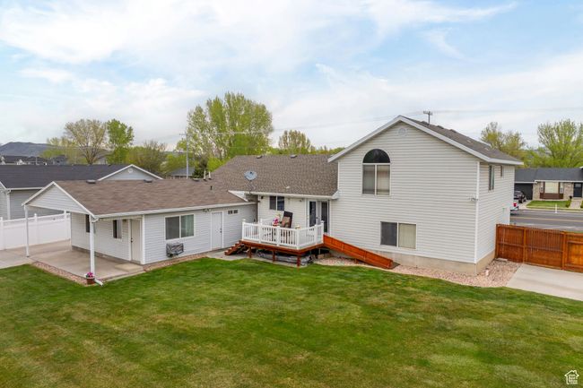 Back of house with fence, a yard, and a deck | Image 58