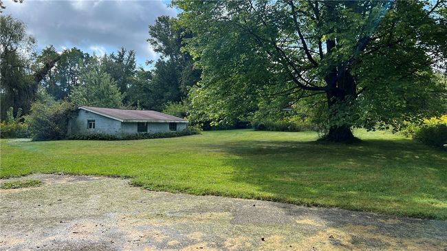The back is flat and has a turn around drive way, out building and a gazebo | Image 6