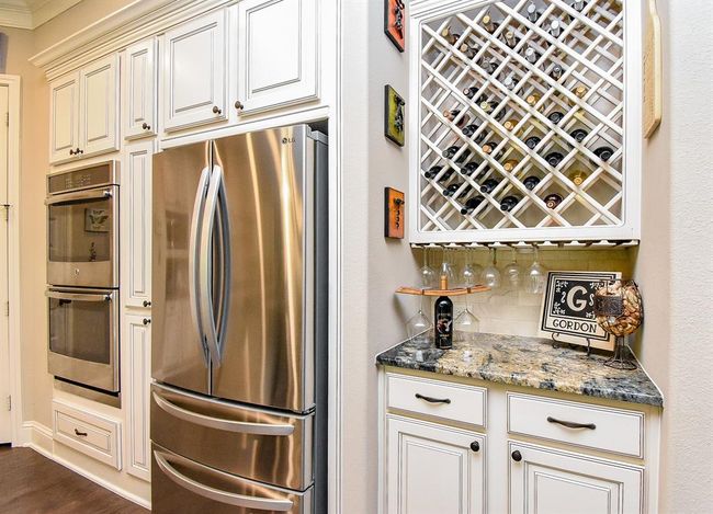 A built-in wine rack with glassware below is just another fine detail to appreciate! | Image 18